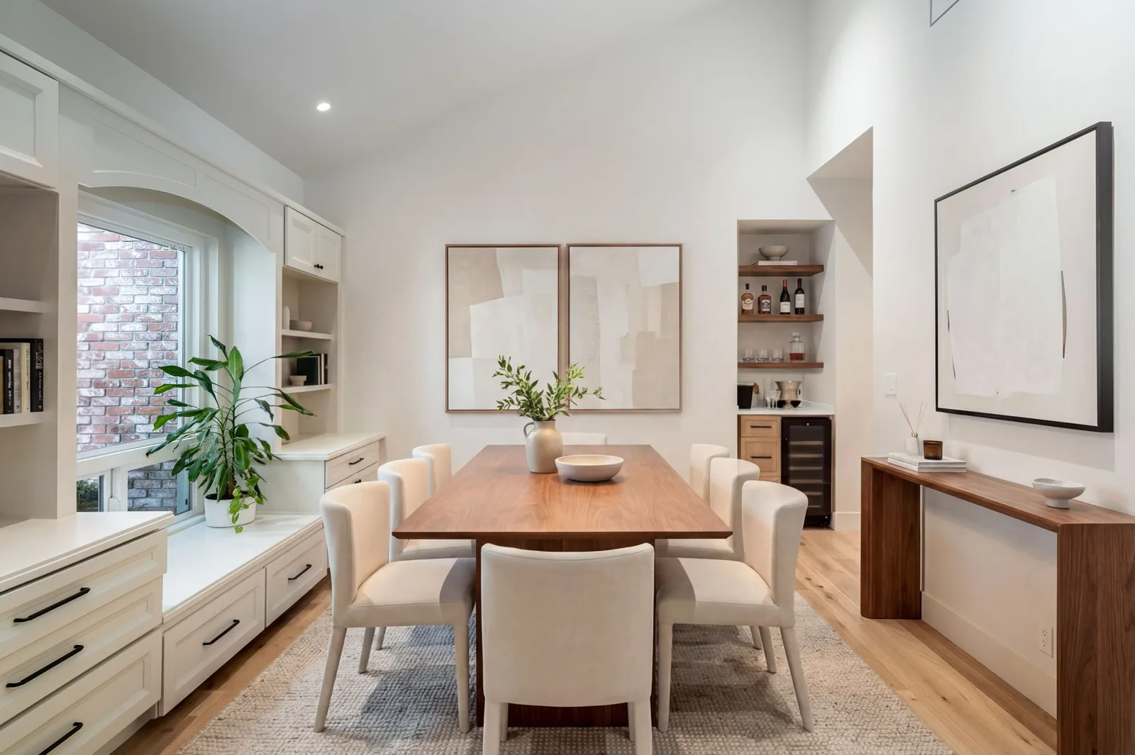 Custom dining room with built-in window seat and walnut table