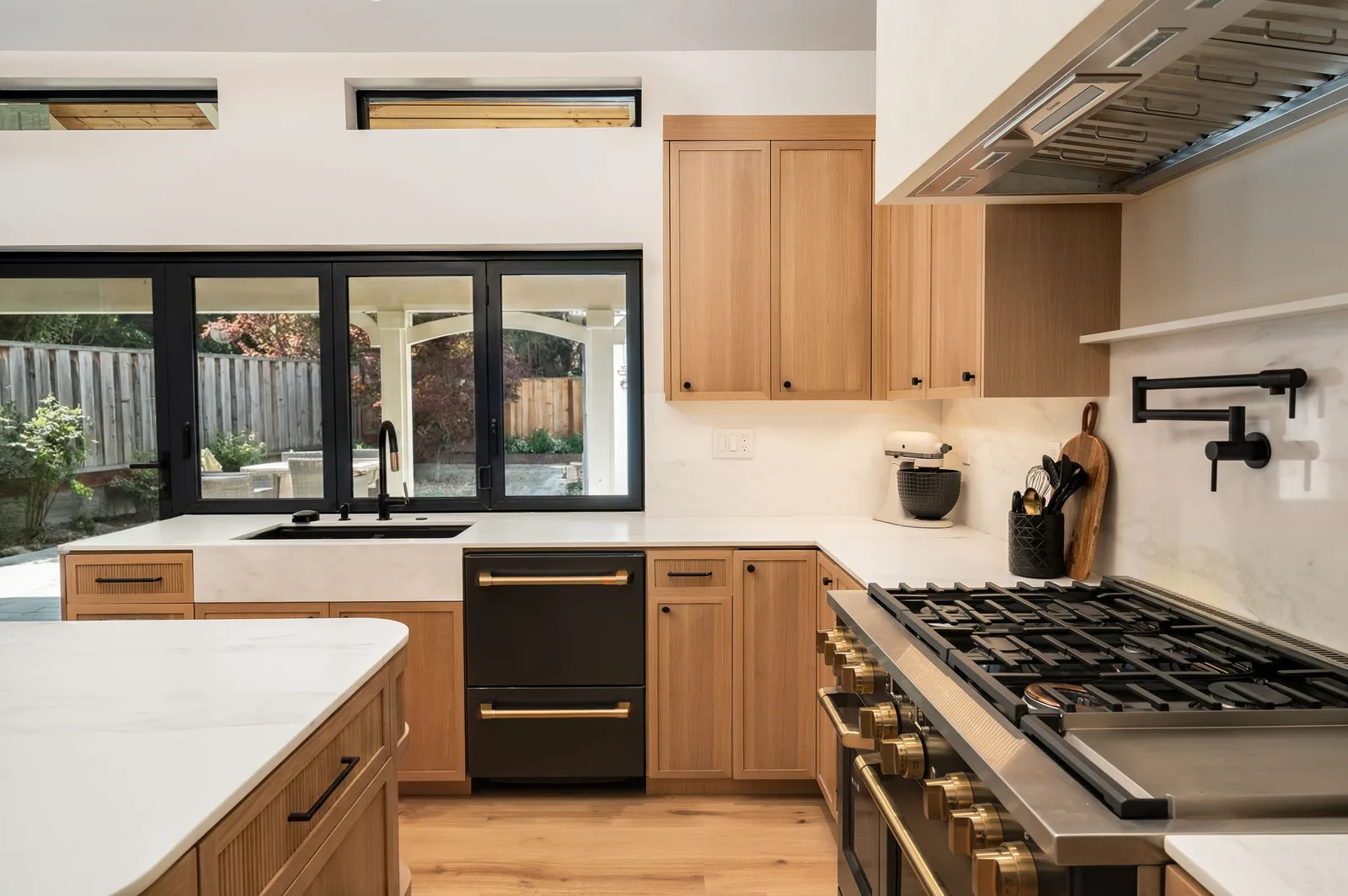 Wide kitchen island with marble waterfall and fluted oak