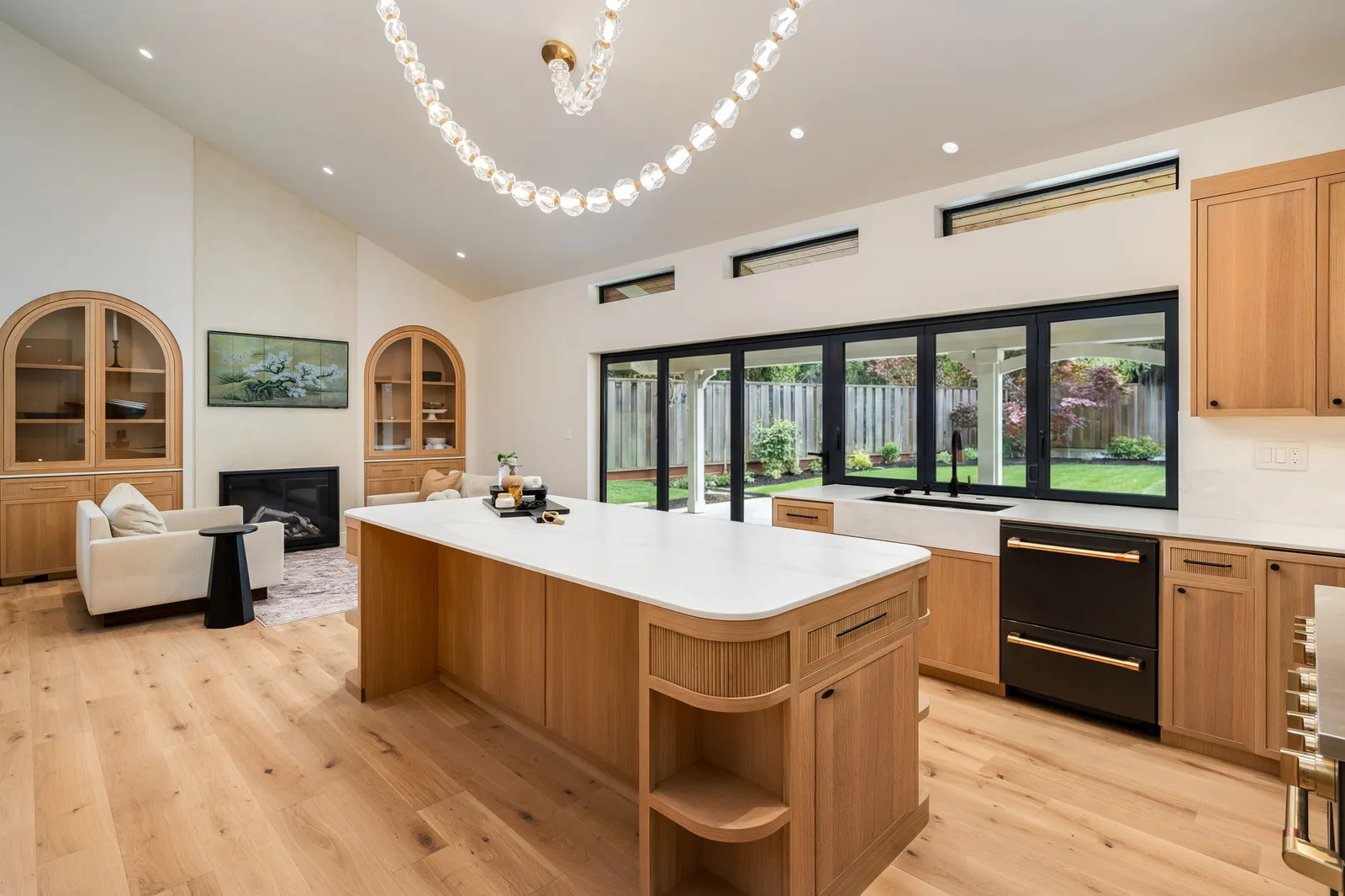 Open kitchen and living area with crystal chandelier